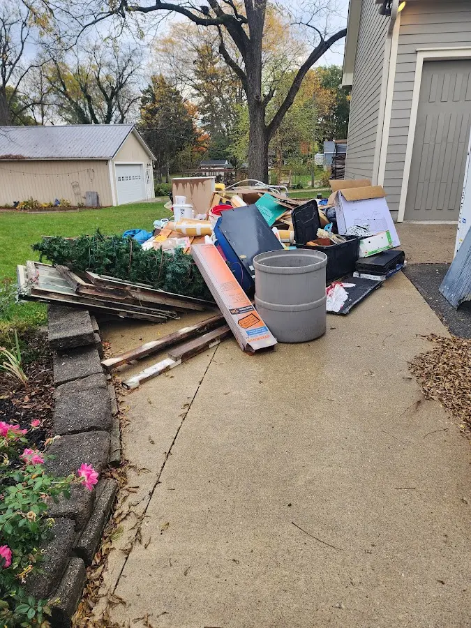 Dumpster being loaded with debris for Roofing Dumpster Rental in Clarksdale